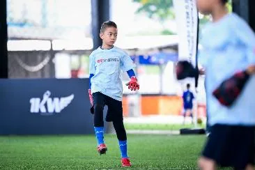 A child in a blue shirt and black shorts running on a field

AI-generated content may be incorrect.