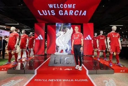 A person standing in front of a display of a sign AI-generated content may be incorrect.