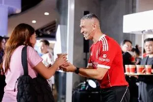 A person holding a cup of coffee AI-generated content may be incorrect.