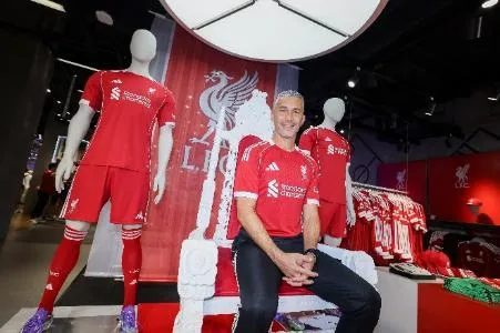 A person sitting in a red shirt AI-generated content may be incorrect.